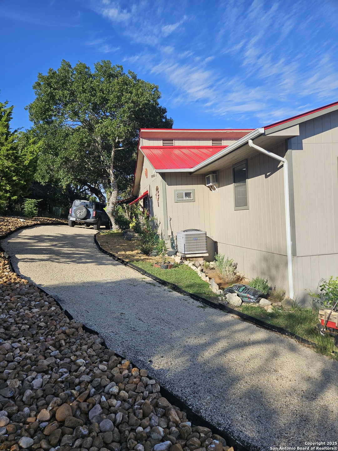 116 Debra Lane Hunt, TX 78024 - Photo 25 of 34 a view of a patio with table and chairs under an umbrella