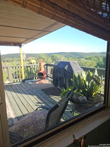 a view of a patio with chairs and potted plants