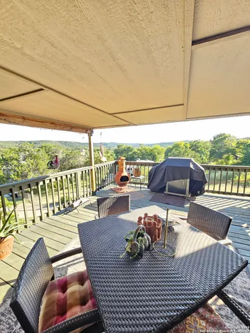 a view of a patio with lawn chairs next to a yard