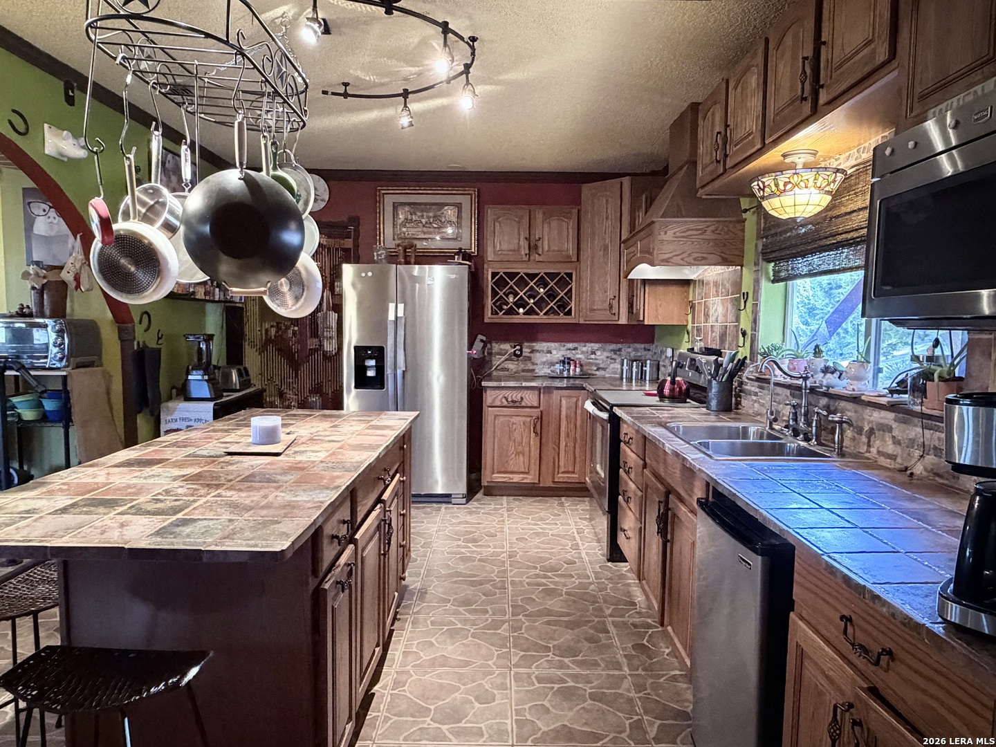116 Debra Lane Hunt, TX 78024 - Photo 6 of 34 a kitchen with stainless steel appliances granite countertop a stove a sink and a microwave