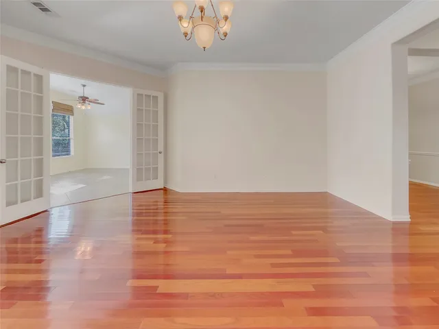 a view of empty room with wooden floor