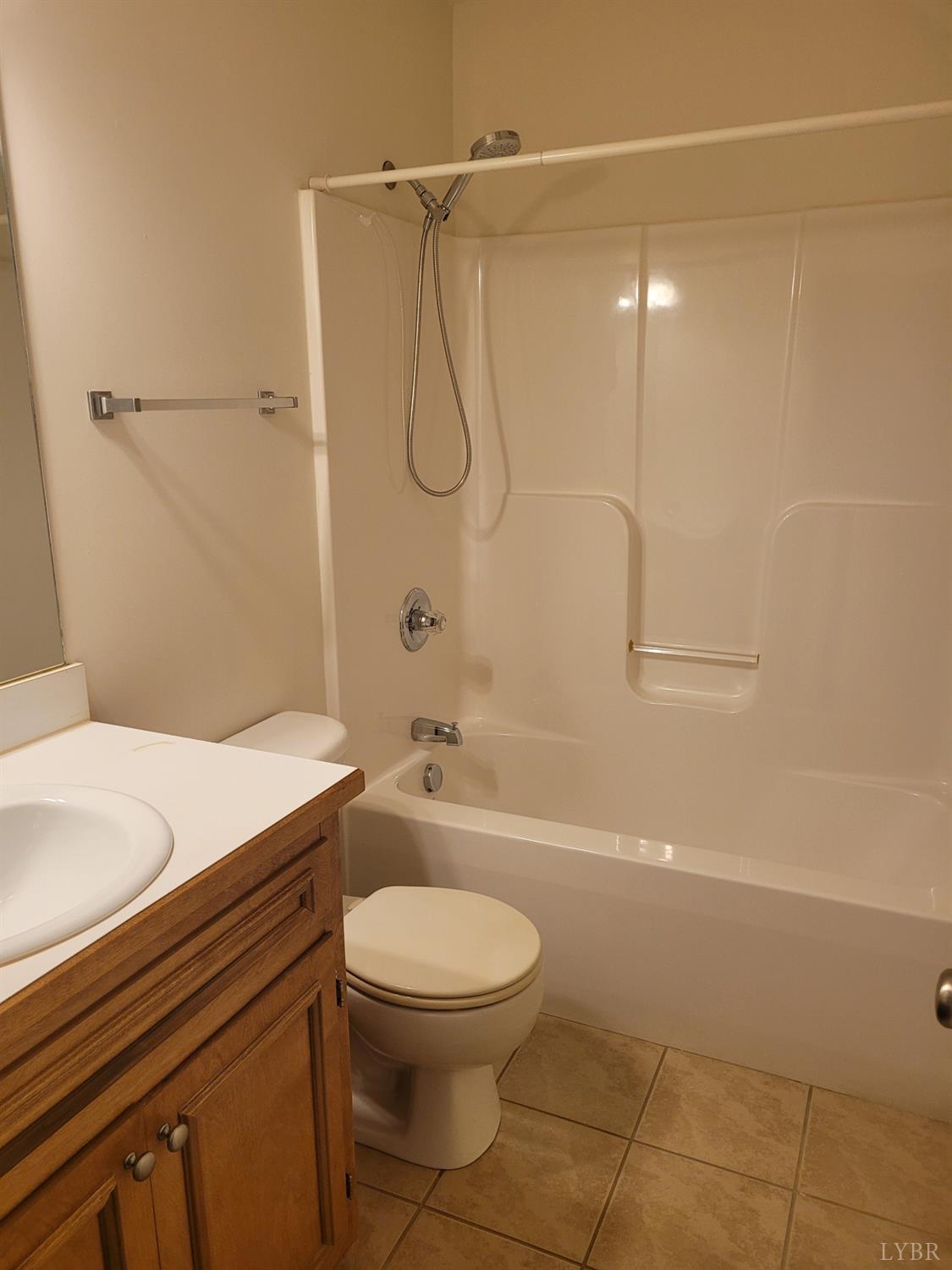 716 Leesville Road, Unit 603 Lynchburg, VA 24502 - Photo 7 of 13 a bathroom with a granite countertop bathtub shower sink vanity and toilet