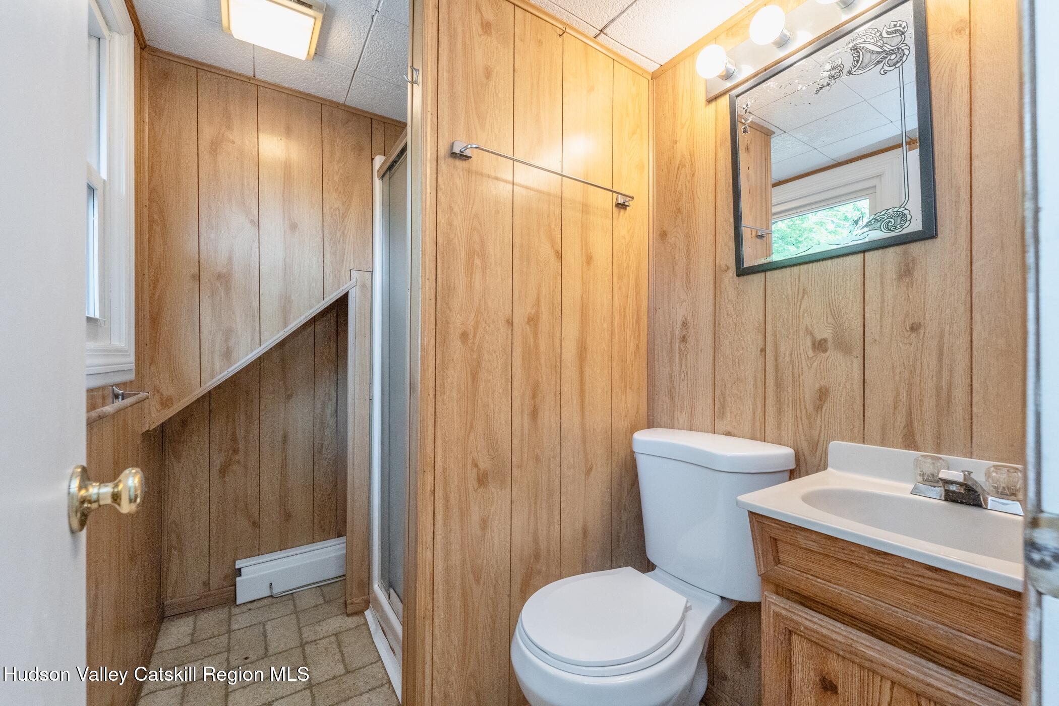4533 Atwood Road Stone Ridge, NY 12484 - Photo 39 of 63 a bathroom with a toilet a sink and a shower