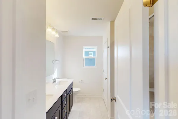 a bathroom with a double vanity sink and mirror