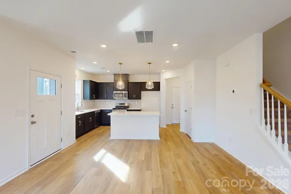 a large kitchen with a large counter top appliances and cabinets