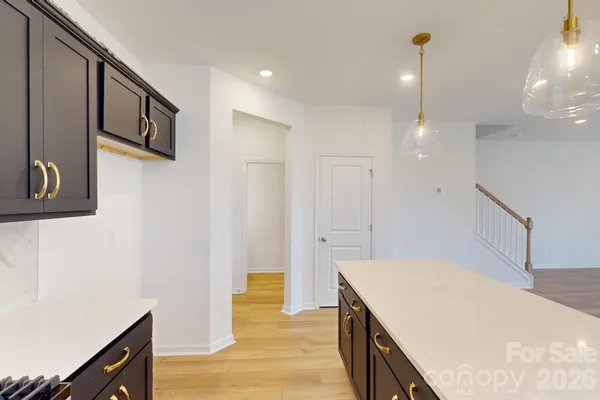 a kitchen with stainless steel appliances a refrigerator and a stove top oven