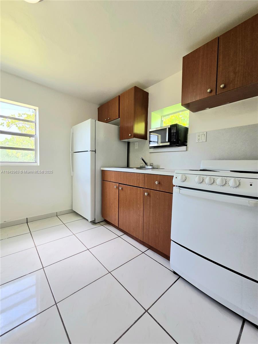 Allapattah Miami, FL 33142 - Photo 3 of 9 a kitchen with a cabinets and a stove top oven