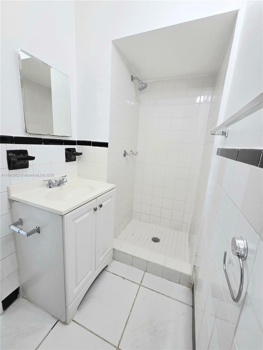 Allapattah Miami, FL 33142 - Photo 7 of 9 a bathroom with a sink a toilet and shower