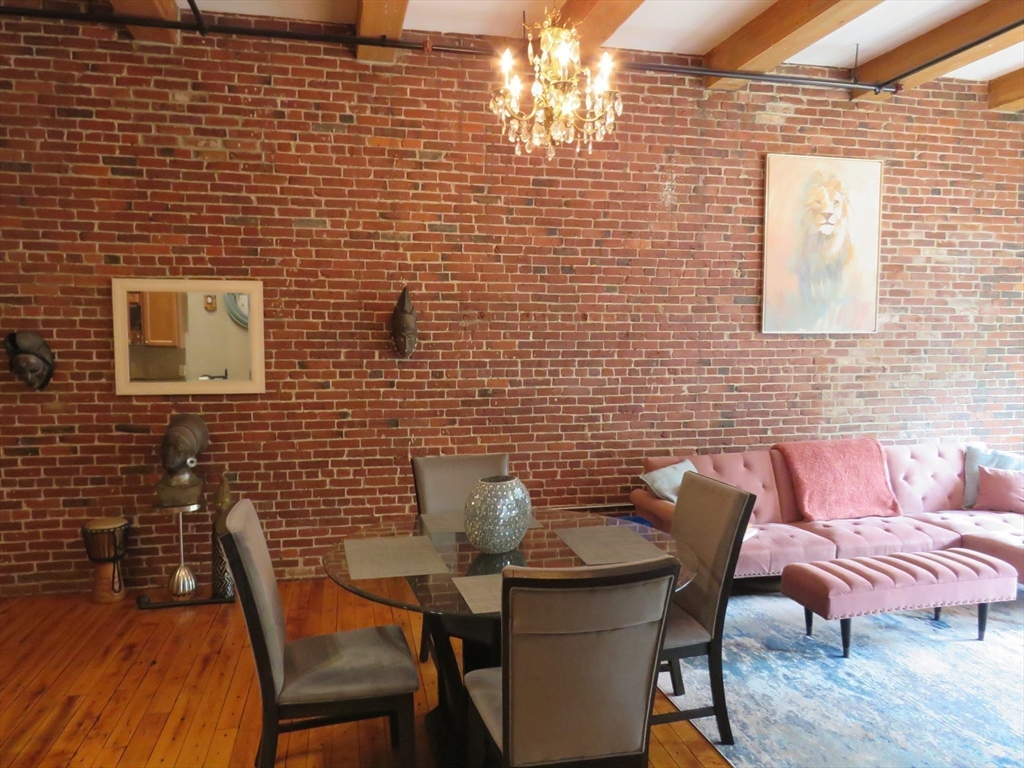 61 Market Street, Unit 2B Lowell, MA 01852 - Photo 5 of 20 a blue and sitting area with brick wall
