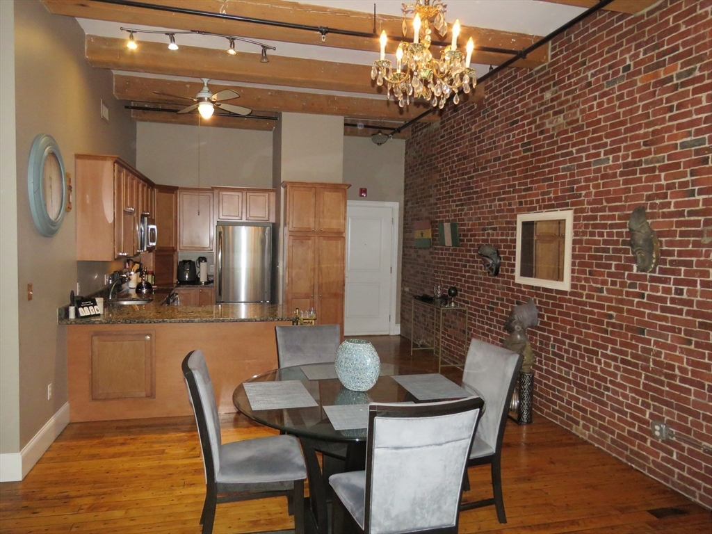 61 Market Street, Unit 2B Lowell, MA 01852 - Photo 6 of 20 a dining room with furniture and window