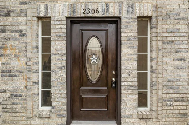 a front view of a house with granite wall
