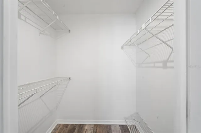 a view of walk in closet with empty racks