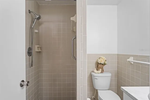 a bathroom with a toilet and a shower