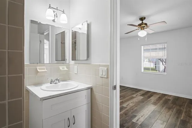 a bathroom with a sink a mirror and a light fixture