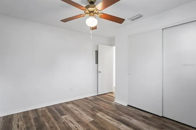 a view of an empty room with a fan