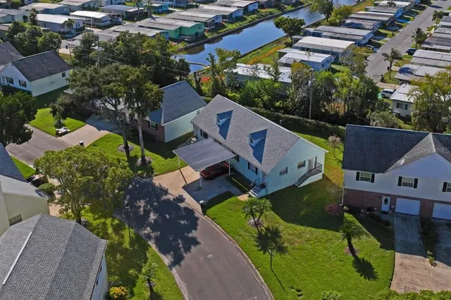 an aerial view of multiple houses with yard