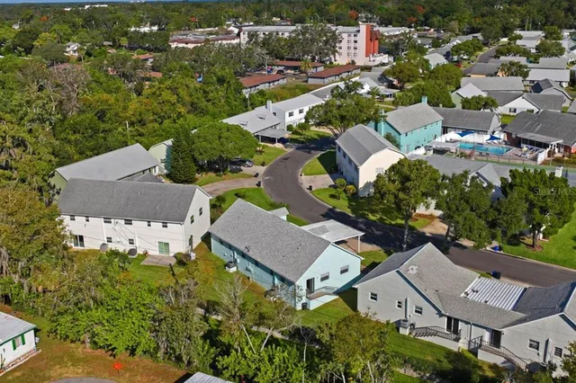 an aerial view of residential houses with outdoor space