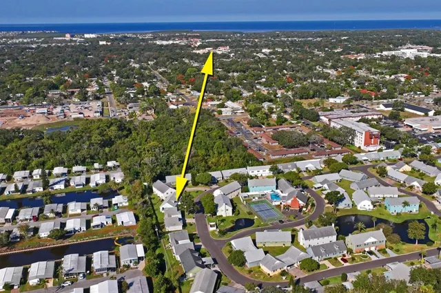 an aerial view of residential houses with outdoor space