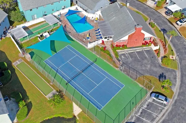 a large kitchen with stainless steel appliances a stove a sink dishwasher a dining table and chairs with wooden floor