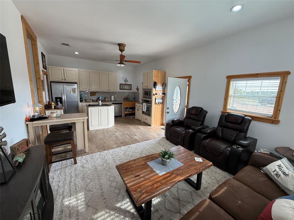 8072 Hells Gate Loop Strawn, TX 76475 - Photo 8 of 16 a living room with furniture fireplace and a flat screen tv
