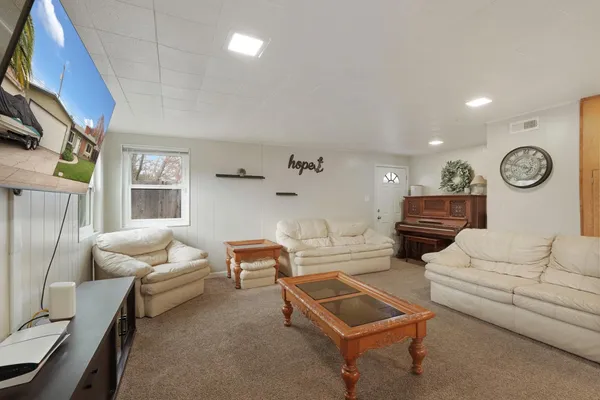 a living room with furniture and a large window