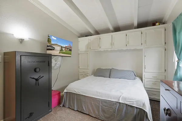 a bedroom with a bed and cabinets