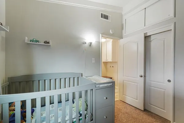 a view of a bedroom with baby bed
