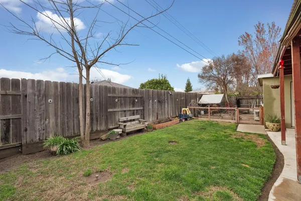 a backyard of a house with table and chairs