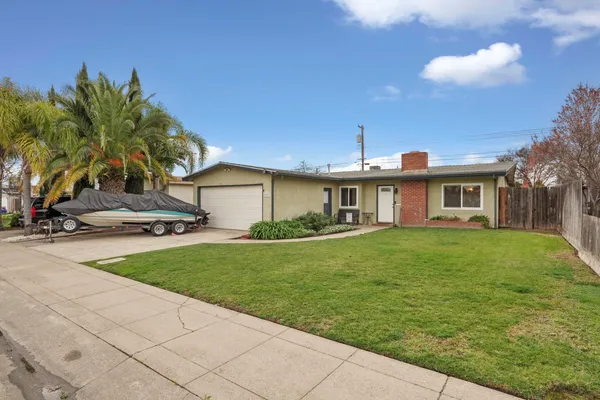 a front view of a house with a garden and yard