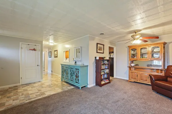 a view of a bedroom with furniture and window