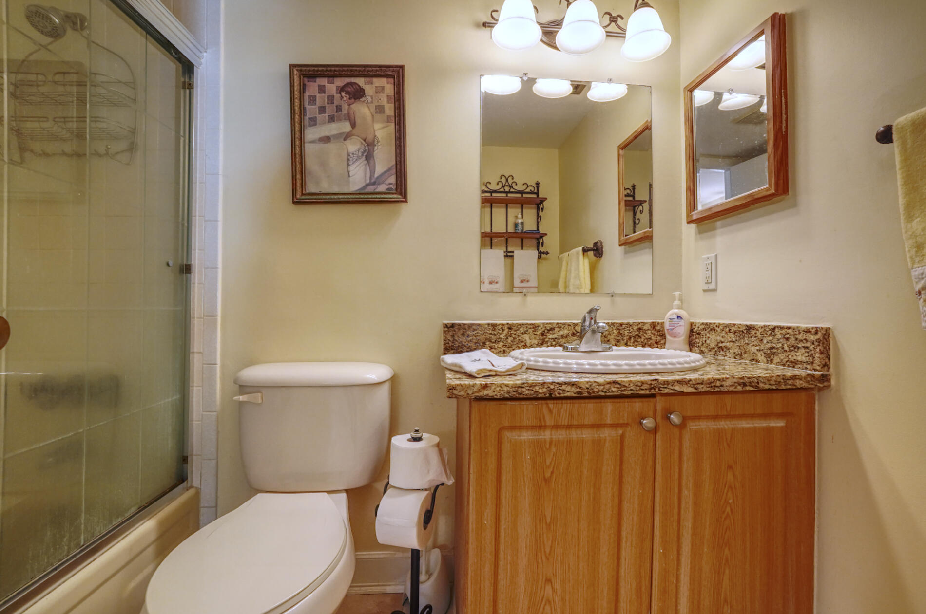 302 Pine Ridge Circle, Unit A2 Greenacres, FL 33463 - Photo 13 of 25 a bathroom with a granite countertop toilet sink and a mirror