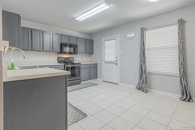 a kitchen with stainless steel appliances granite countertop a sink and cabinets