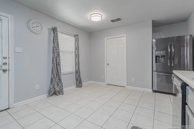 a spacious bedroom with a bed and a table in it