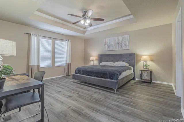 a bedroom with a bed and a lamp on dresser