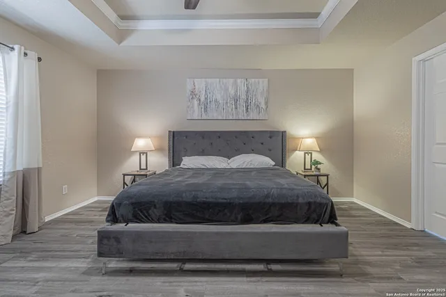 a bedroom with a bed and a chandelier