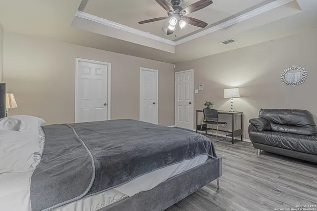 a bedroom with a bed and a chandelier