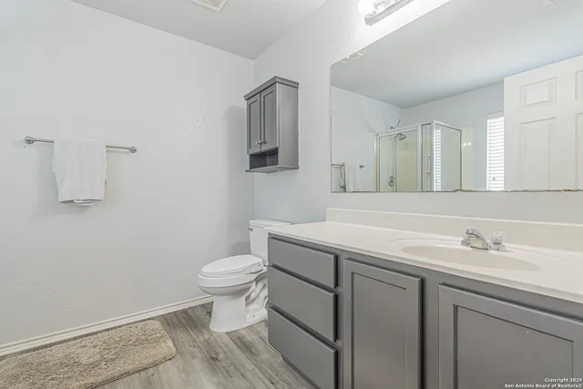 a bathroom with a sink toilet and shower