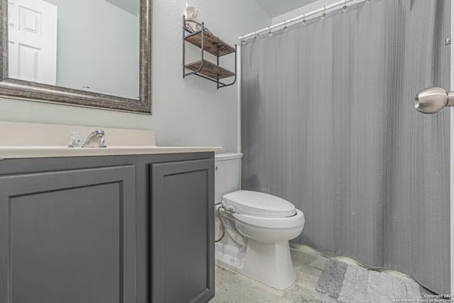 a spacious bedroom with a bed and a chandelier
