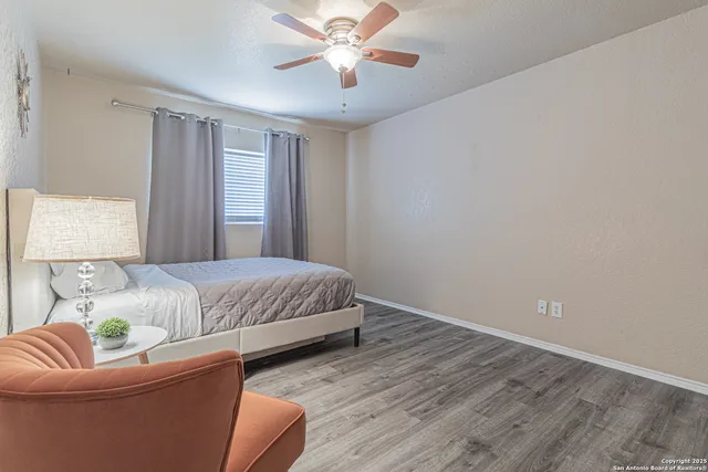 a bedroom with a bed and chair