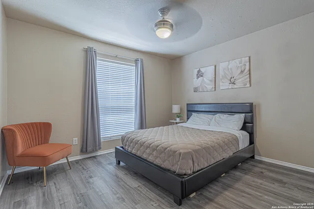 a bedroom with a large bed and a chandelier