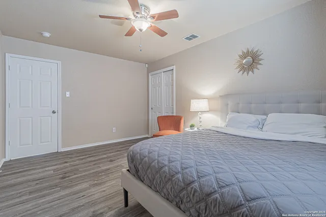 a bedroom with a bed and wooden floor