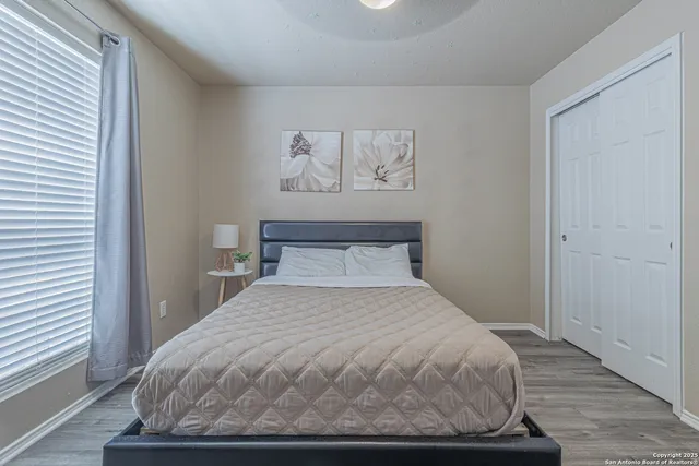 a view of a yard with a house and a large tree
