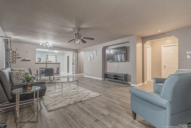 a living room with furniture and wooden floor