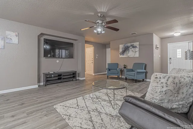 a living room with furniture and wooden floor