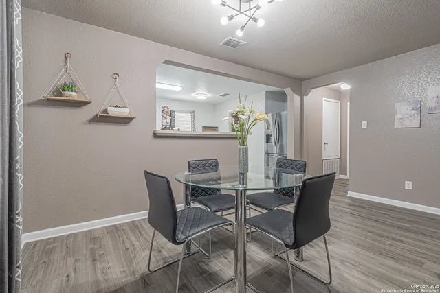 a view of a dining room with furniture and wooden floor