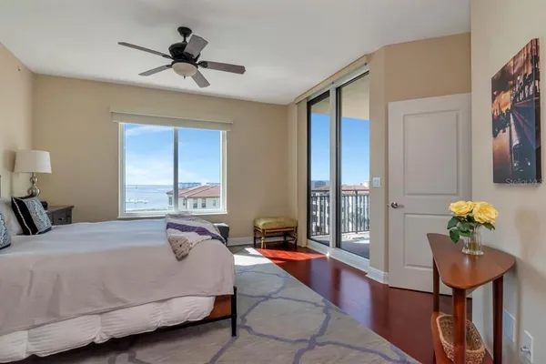 a bathroom with a granite countertop sink a large mirror and a bathtub