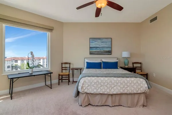 a bedroom with a bed and a chandelier
