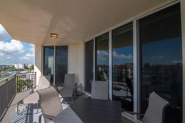 a view of balcony with wooden floor and outdoor seating