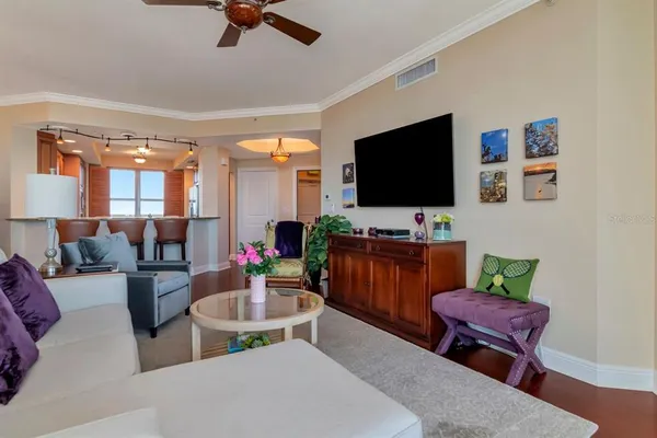 a dining room filled chandelier and wooden furniture
