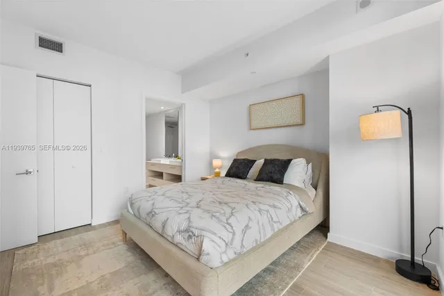 a bedroom with a bed and a lamp